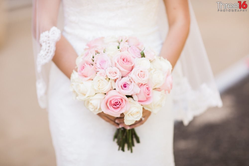 Bride holds her beautiful bouquet of pink and white flowers