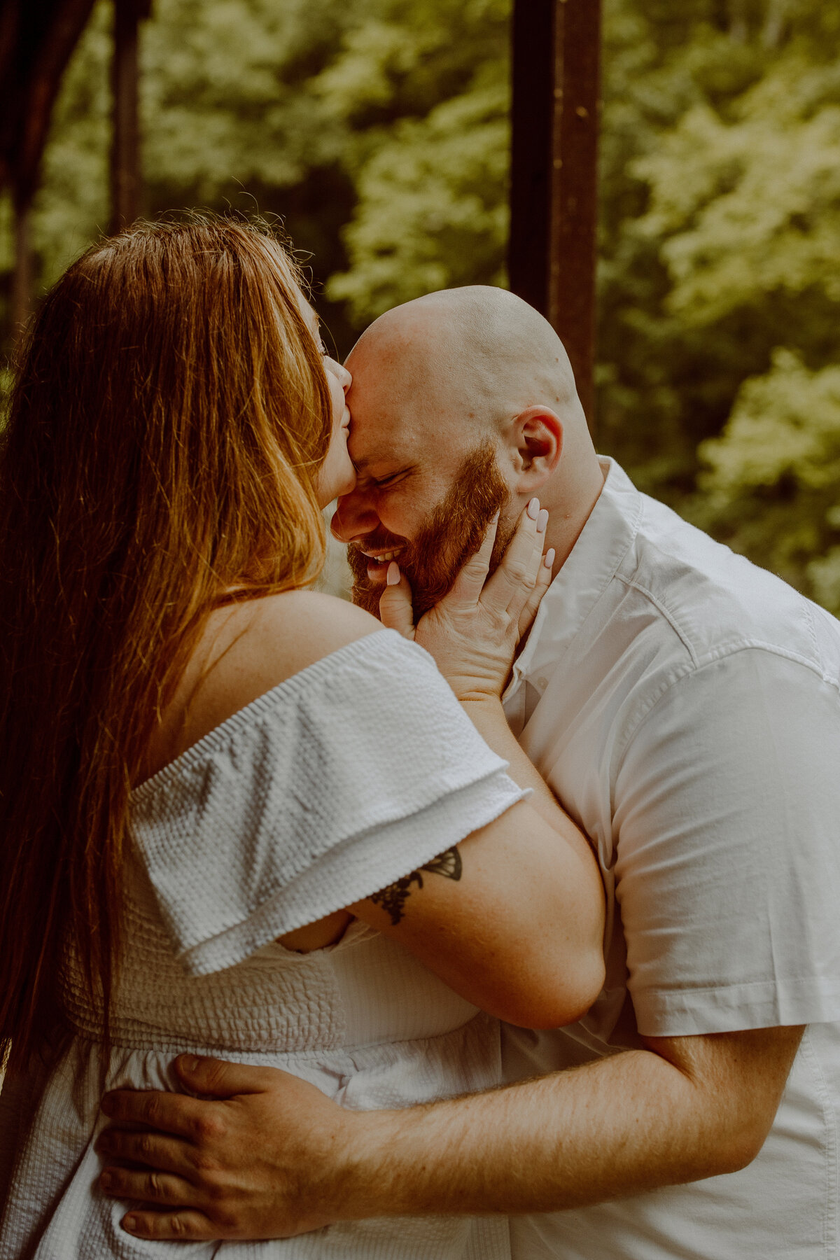 couple kissing during engagement photos outside