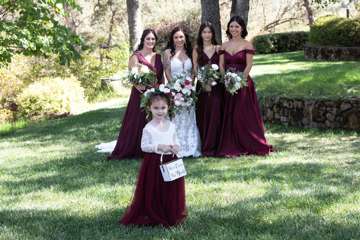 flower girl in front of bridal party