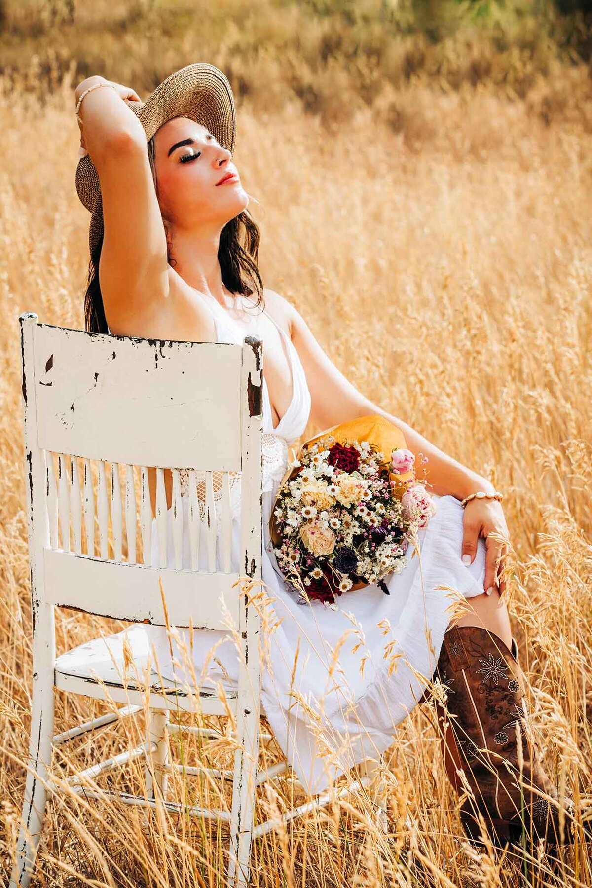 Senior photo of Missoula girl sitting on chair in field