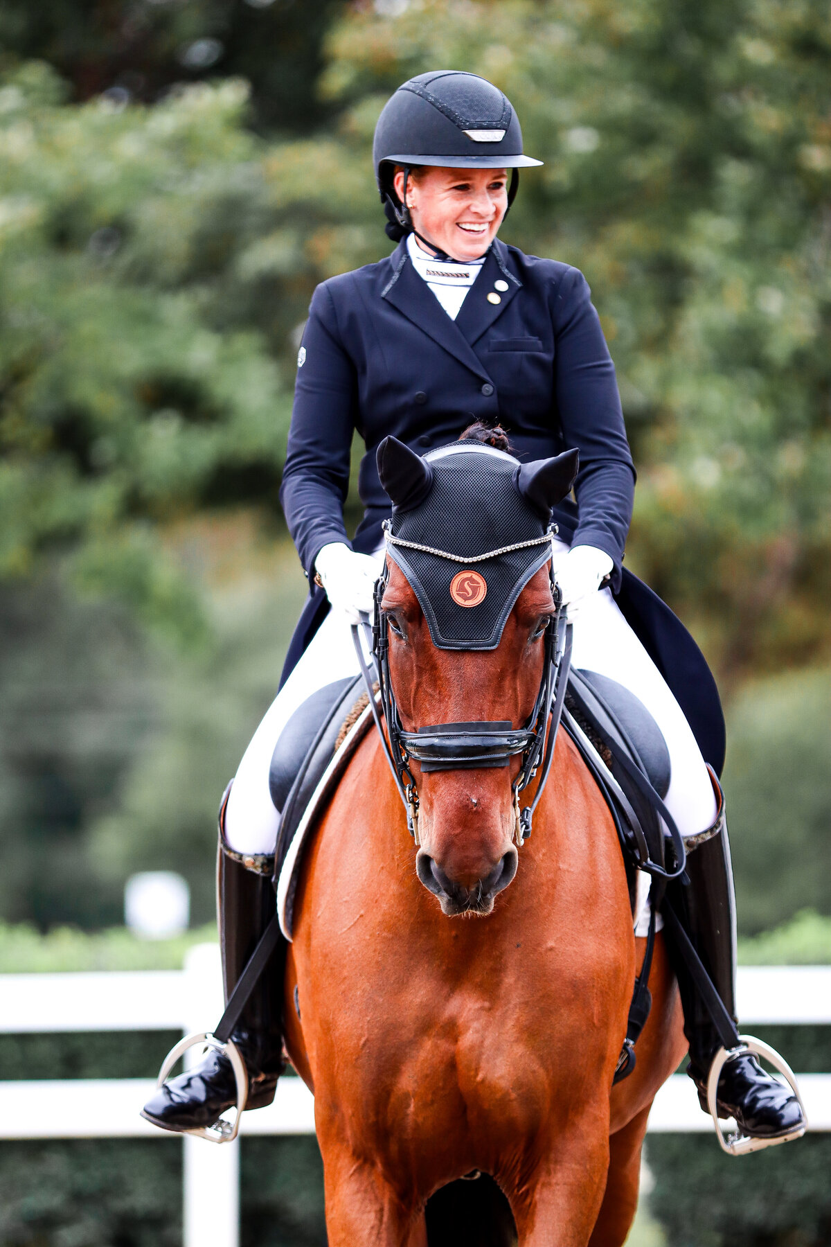 A straight on shot of a rider smiling on a bay dressage horse at the Georgia International Horse Park during a horse show in Conyers, Georgia.