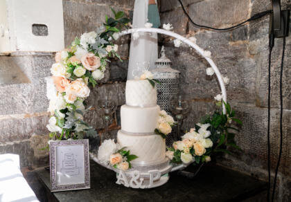 A wedding cake on a table with flowers