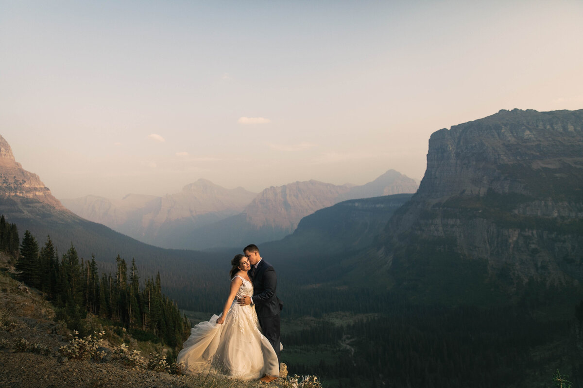couple kissing in front of mountains