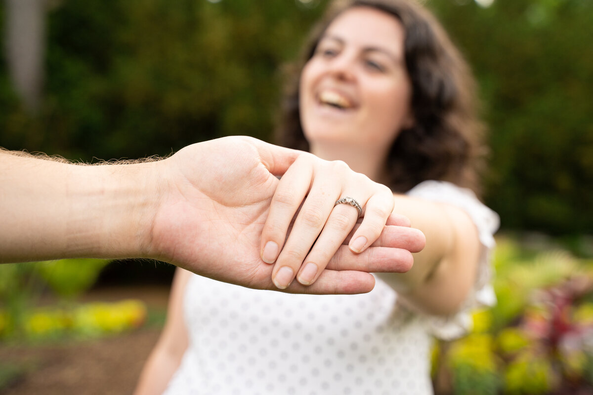 Zach Hamilton shows off his wife's wedding ring while she laughs at Inniswood Metro Gardens in Westerville, Ohio