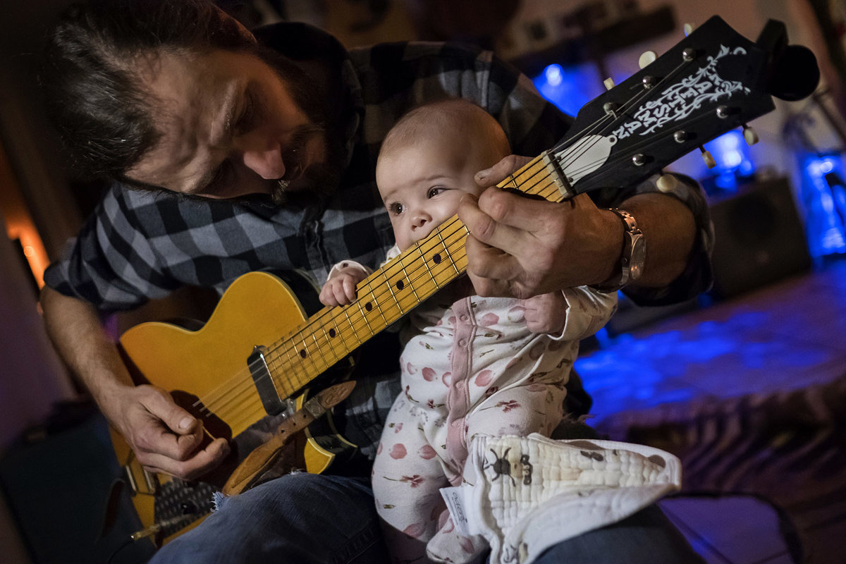 Newborn with musician father and guitar by King and Fields Studios Charleston SC