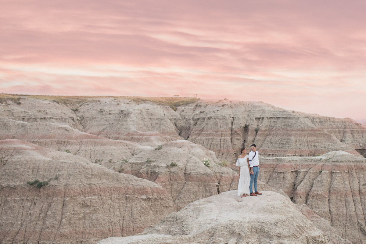 Engaged native american South Dakota couple standing on top of the Badlands National Park