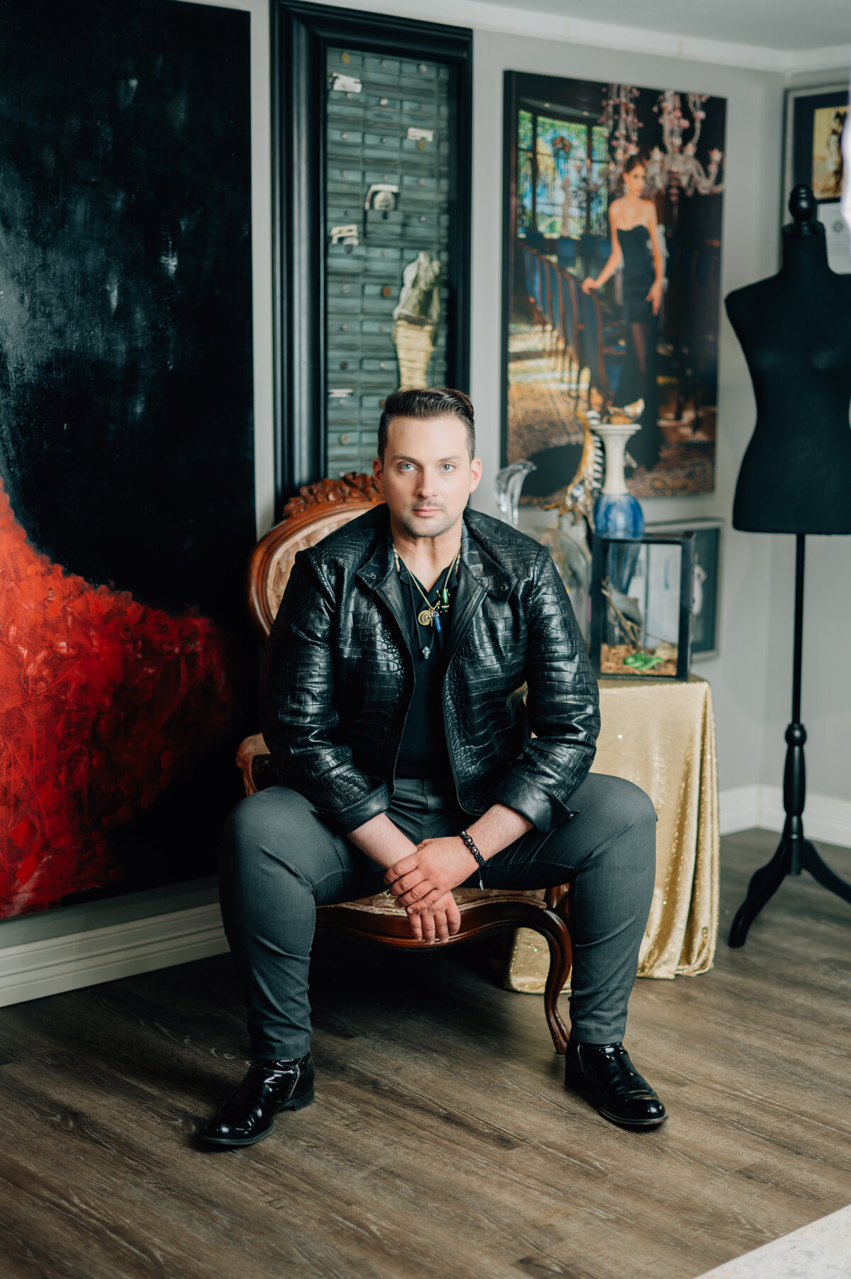 Jonathan Blake in leather chair with red backdrop for Houston brand session