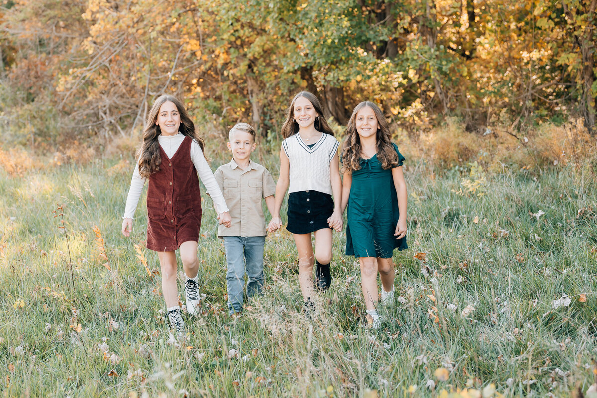 siblings-walking-in-fall-meadow