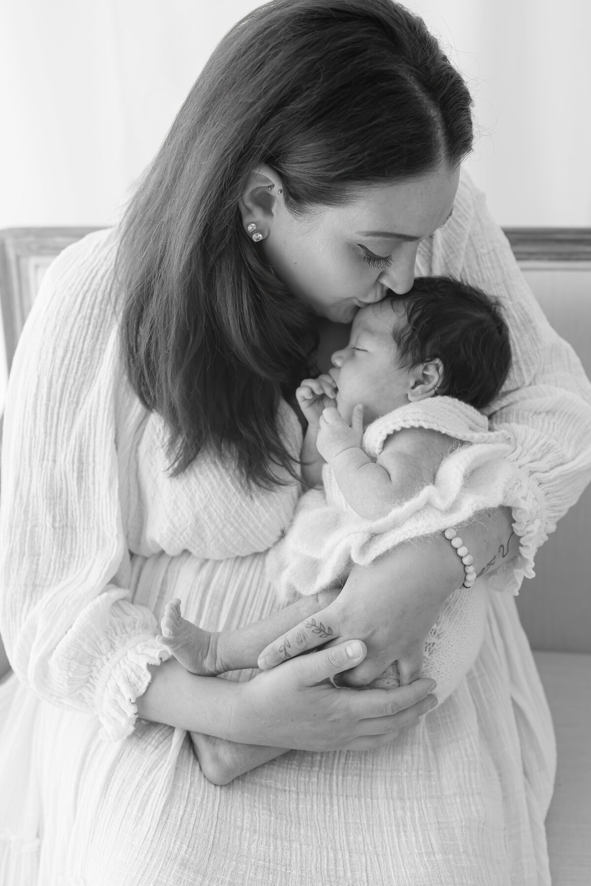 Mom cuddling baby during natural light Barrie newborn photography session 