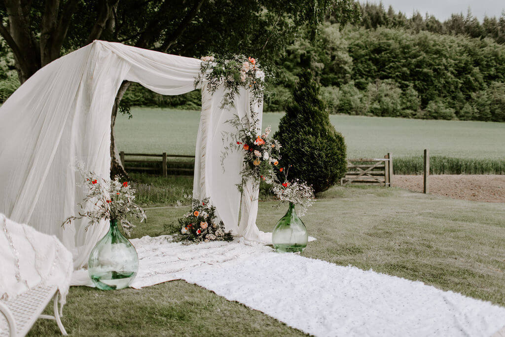 ARCH WITH DRAPES AT A PRIVATE HOME IN HEREFORD FOR A WEDDING