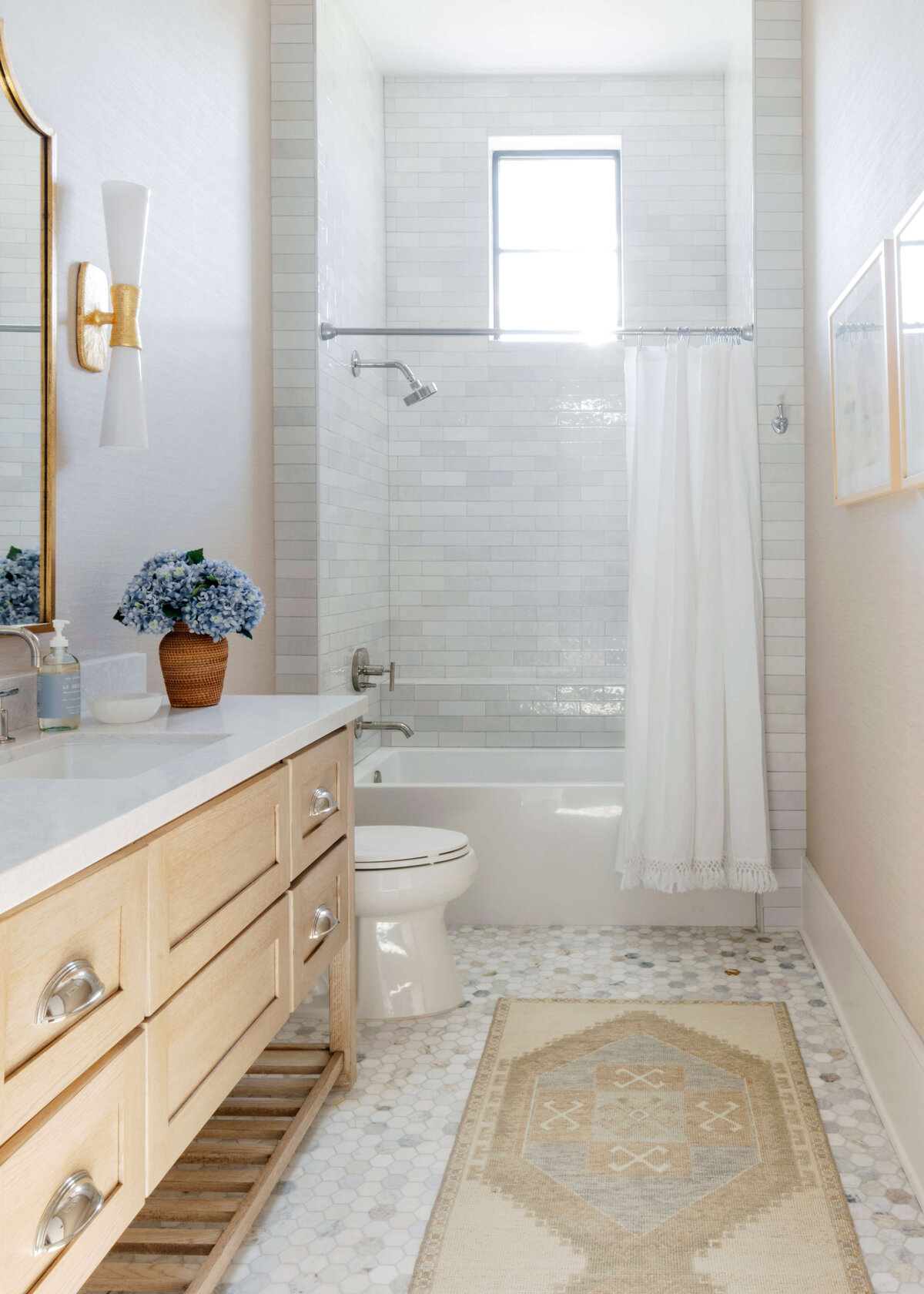 oyster creek studios hughes wooden vanity and white tiled shower and runner rug in bathroom