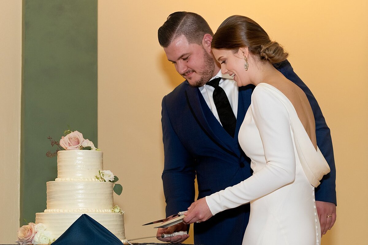 NFL free agent Groom and his Bride cut their simple but elegant wedding cake at Soldiers and Sailors Memorial Hall in Pittsburgh, PA