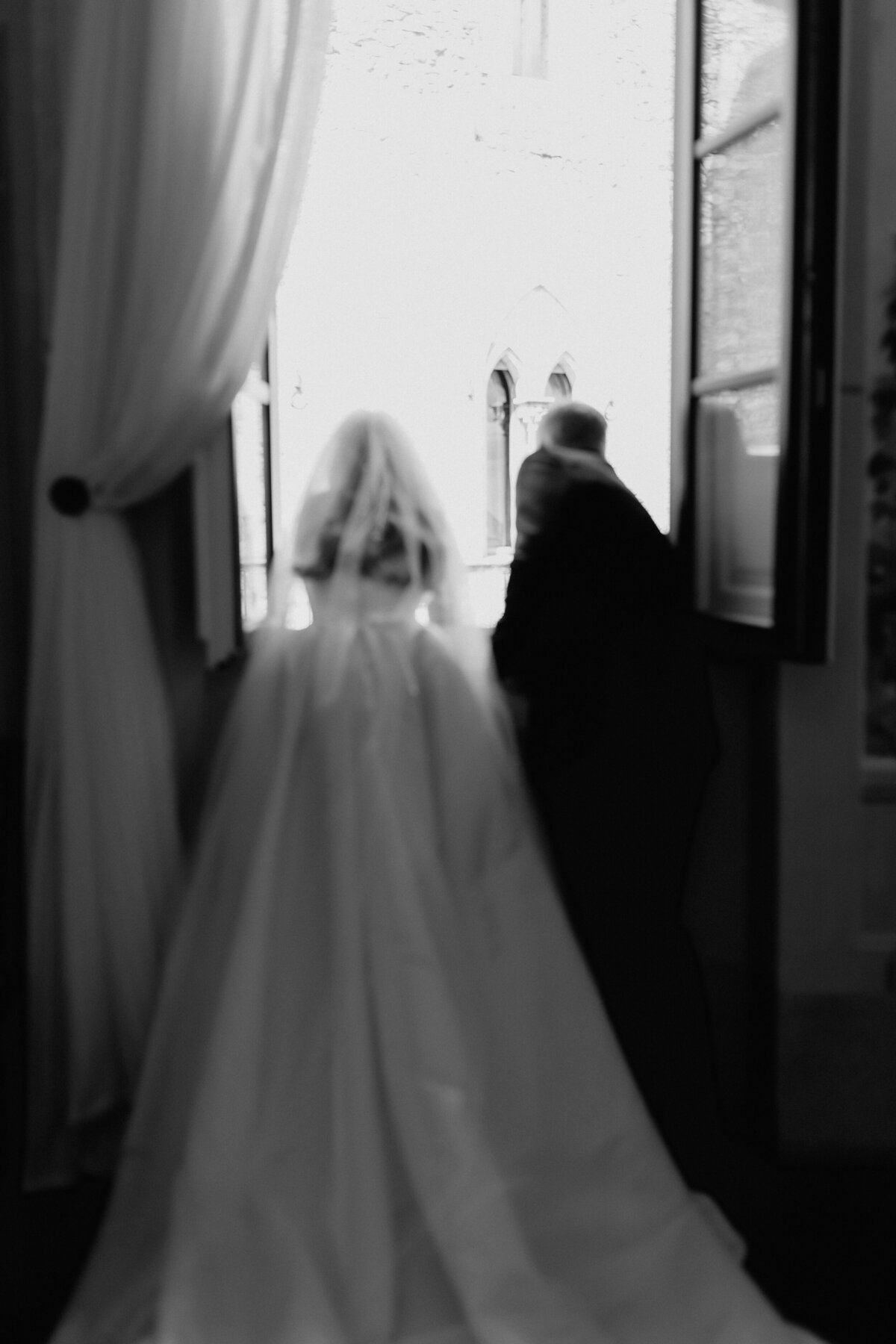 Father and Bride looking out window in Castle in Italy