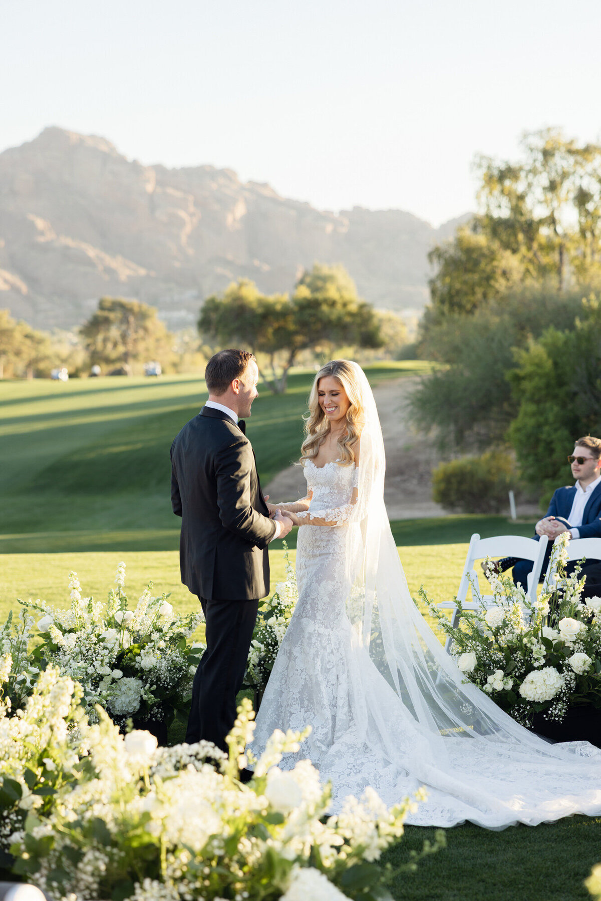 Bride and groom holding hands during ceremony at Paradise Valley Country Club in Arizona