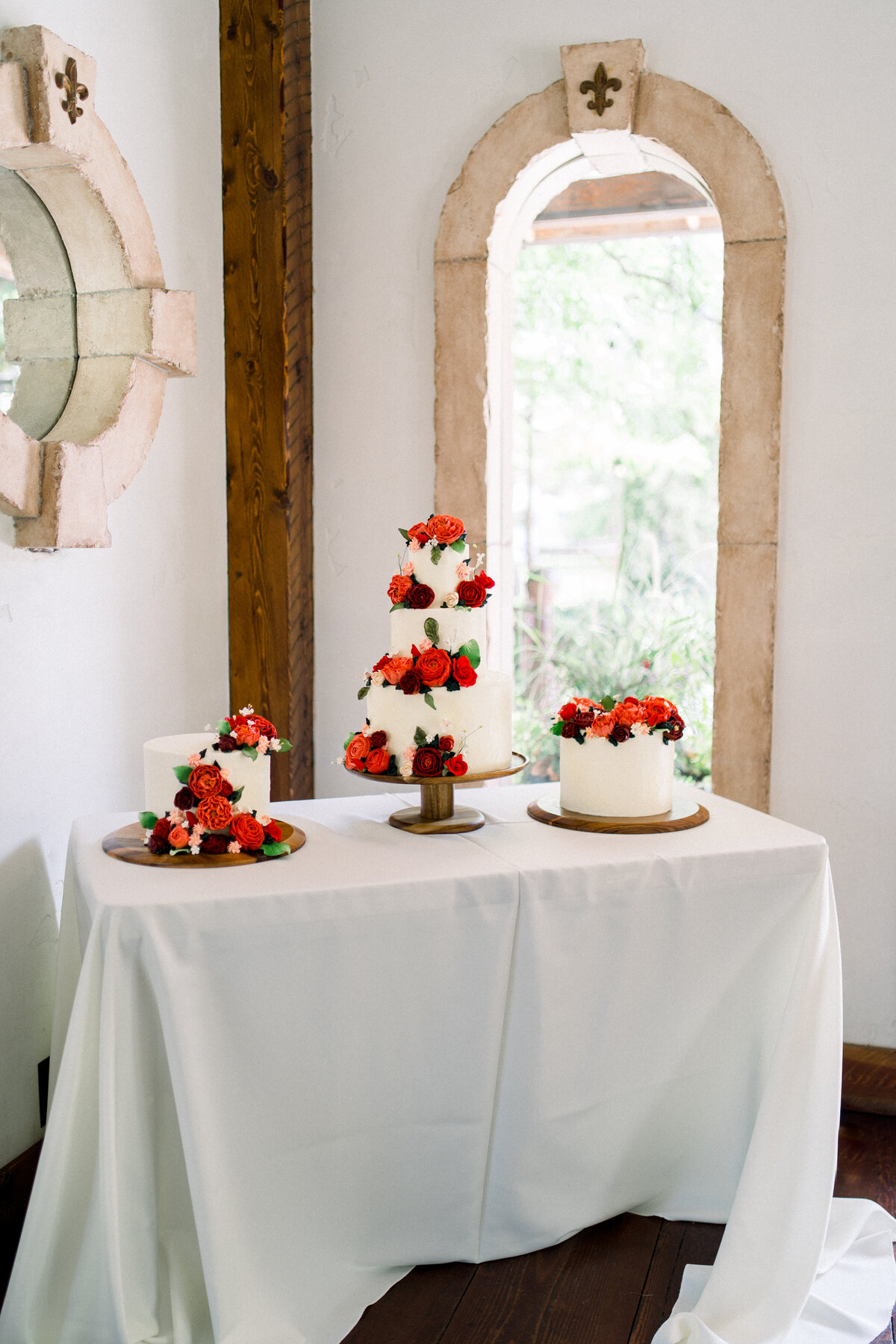 Wedding cake with red flowers at Vizcaya Sacramento, CA