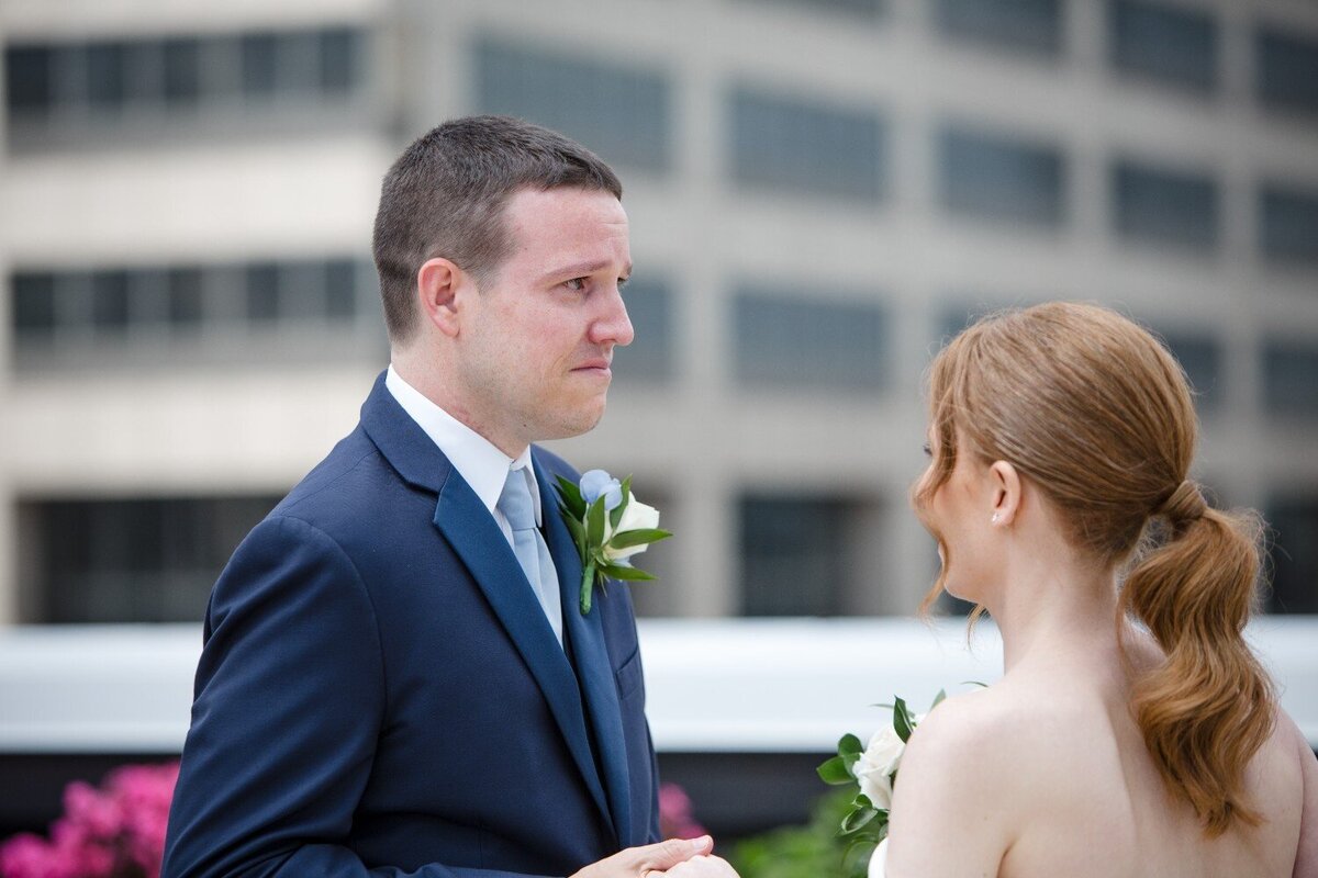 emotional-groom-during-first-look-jps-events-rooftop.jpg