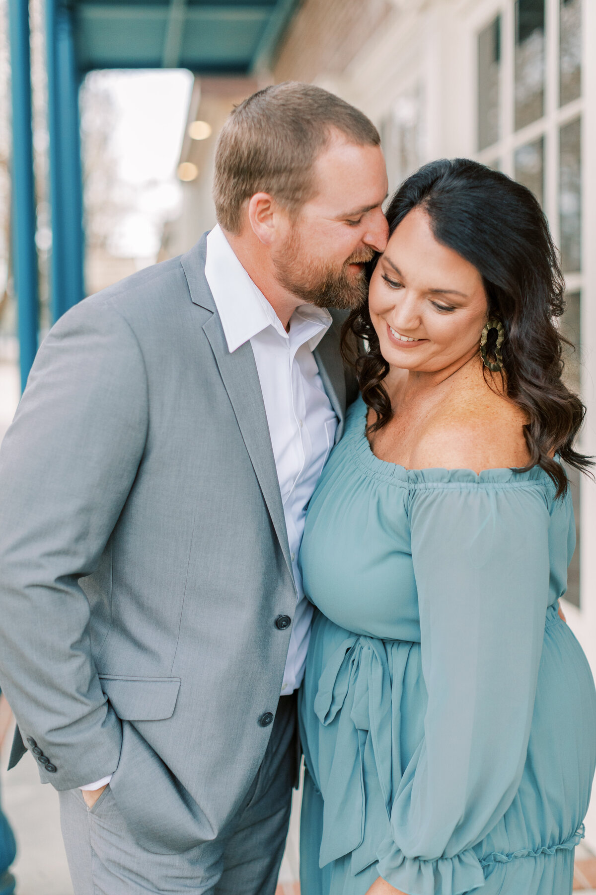 A couple snuggles with each other in downtown Hattiesburg.