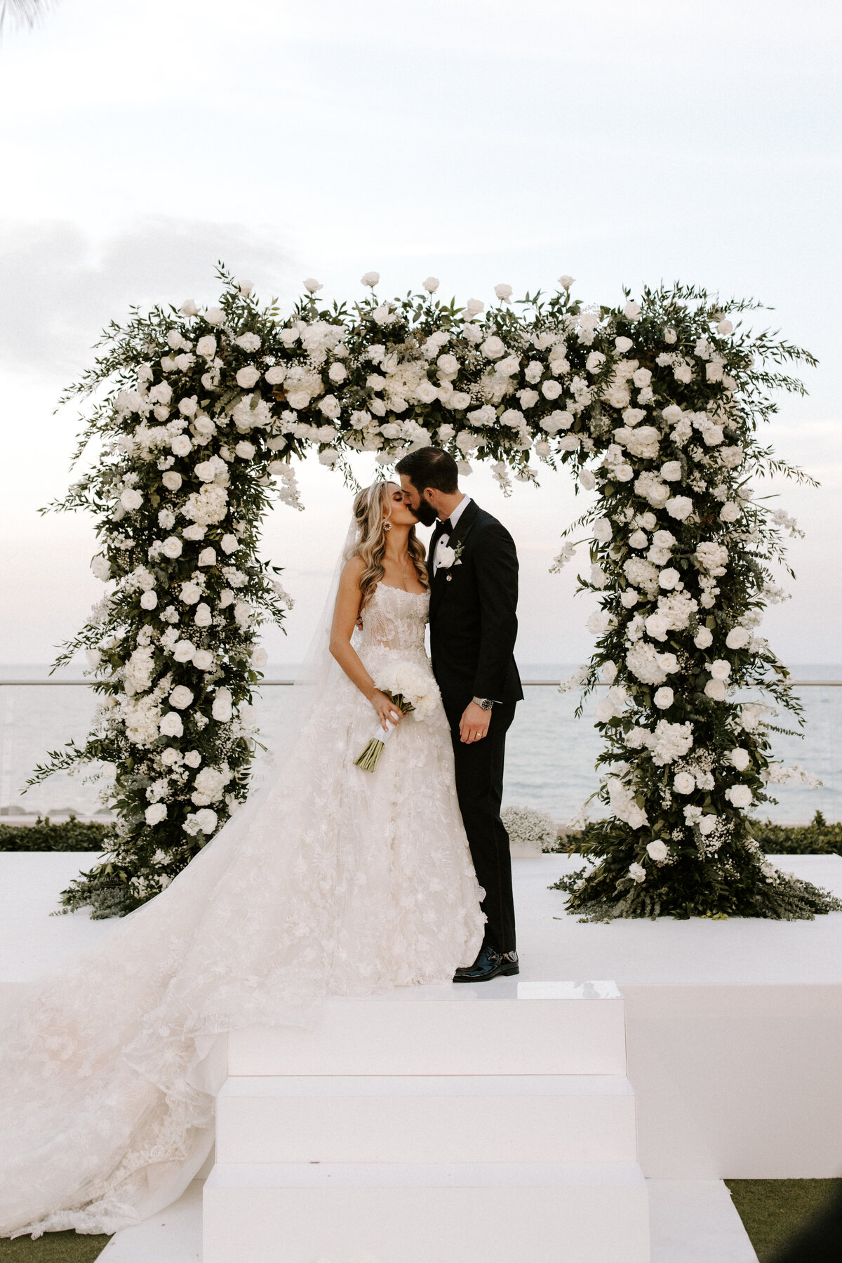 First Kiss Wedding Ceremony Altar with Floral Arch