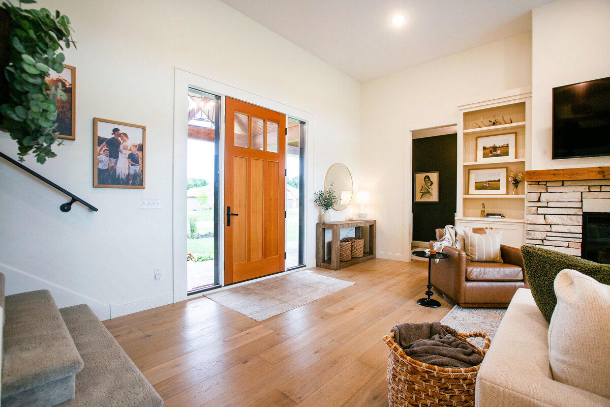 Light-filled entryway with wood flooring and neutral tones in a custom-built Otsego home