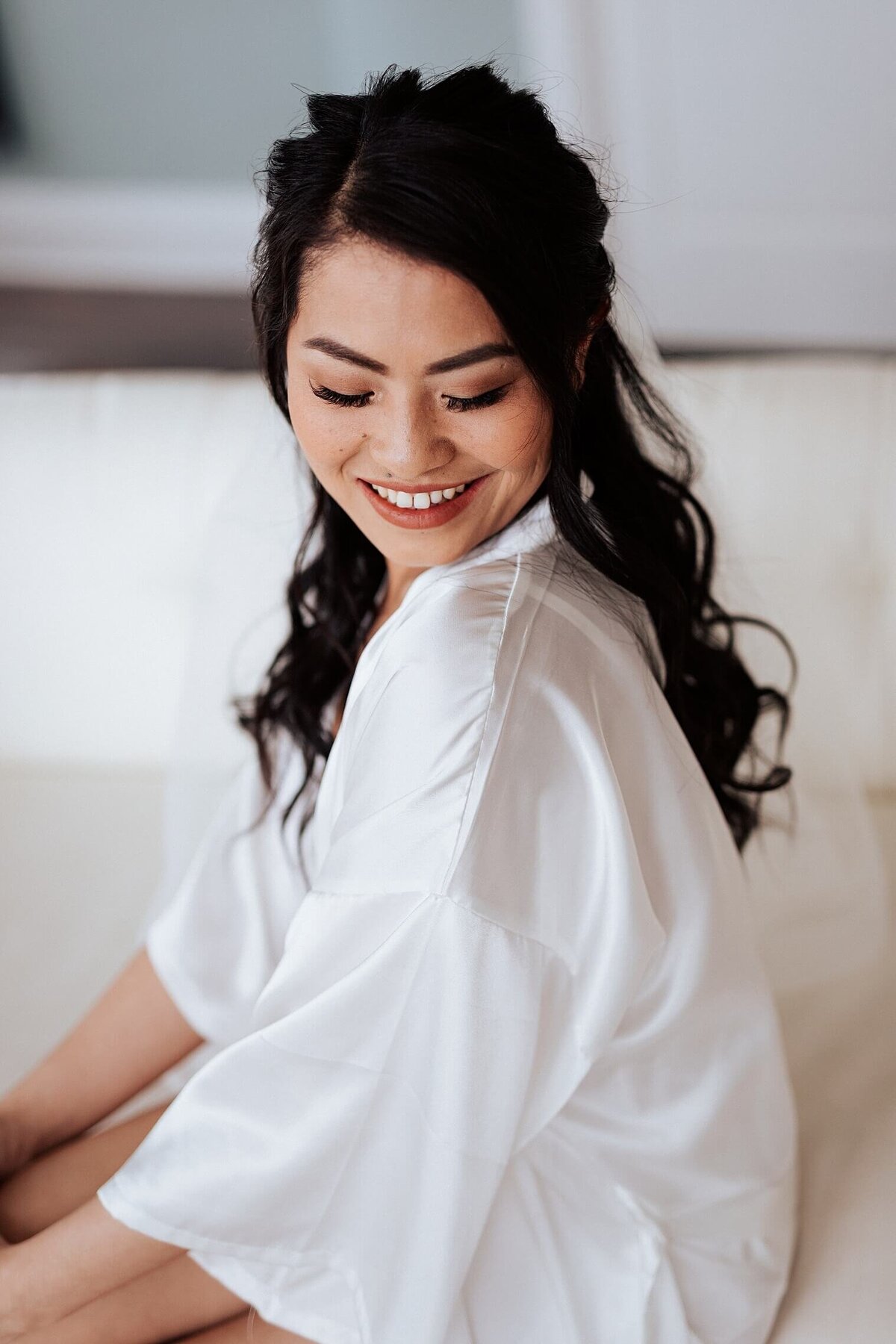 Bridalo protrait with her smiling down her shoulder