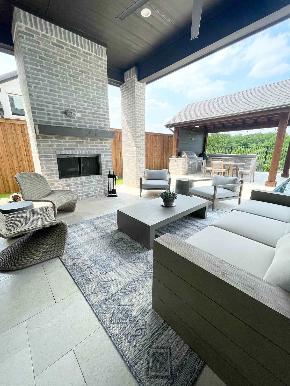 Personalized home design service for an outside living room with elegant decoration, showcasing stylish furniture, sophisticated lighting, and a serene atmosphere for an upscale outdoor living space.
