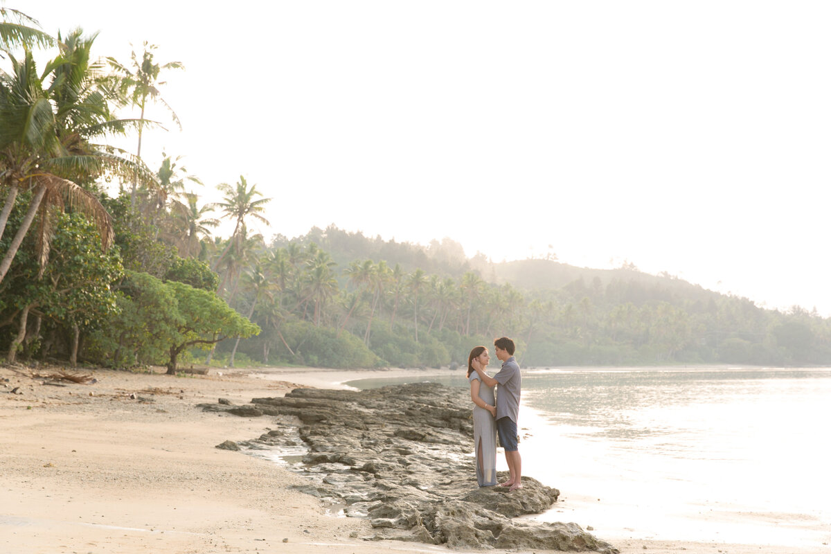 couple standing on a misty beach