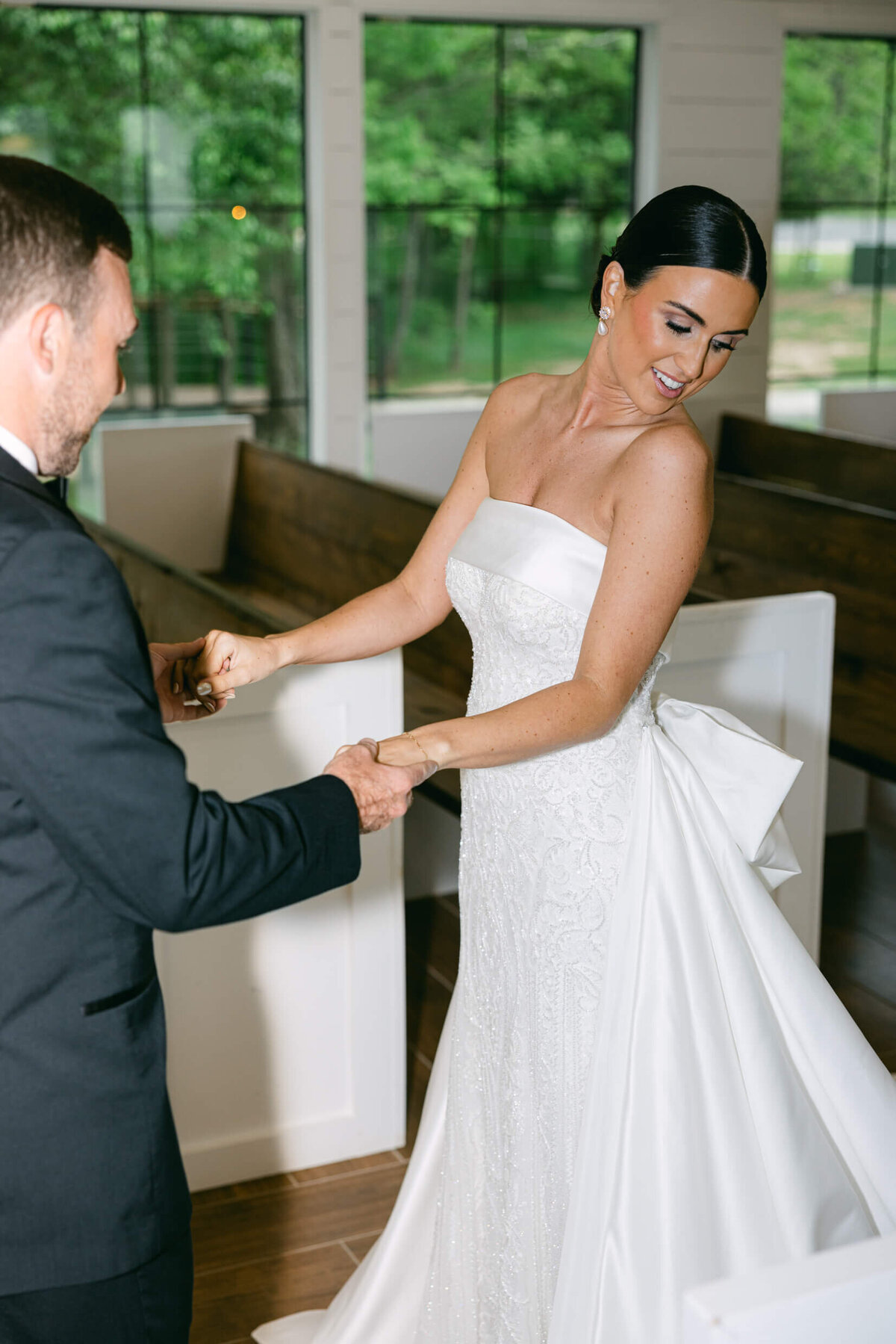 A candid wedding day photo of the bride and groom during their first look