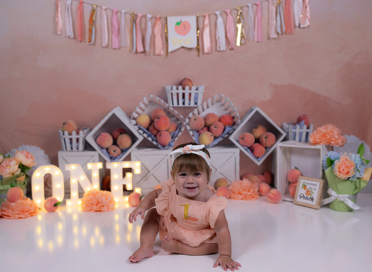 Fruit themed cake smash with peaches backdrop – Bergen County NJ first birthday photography session