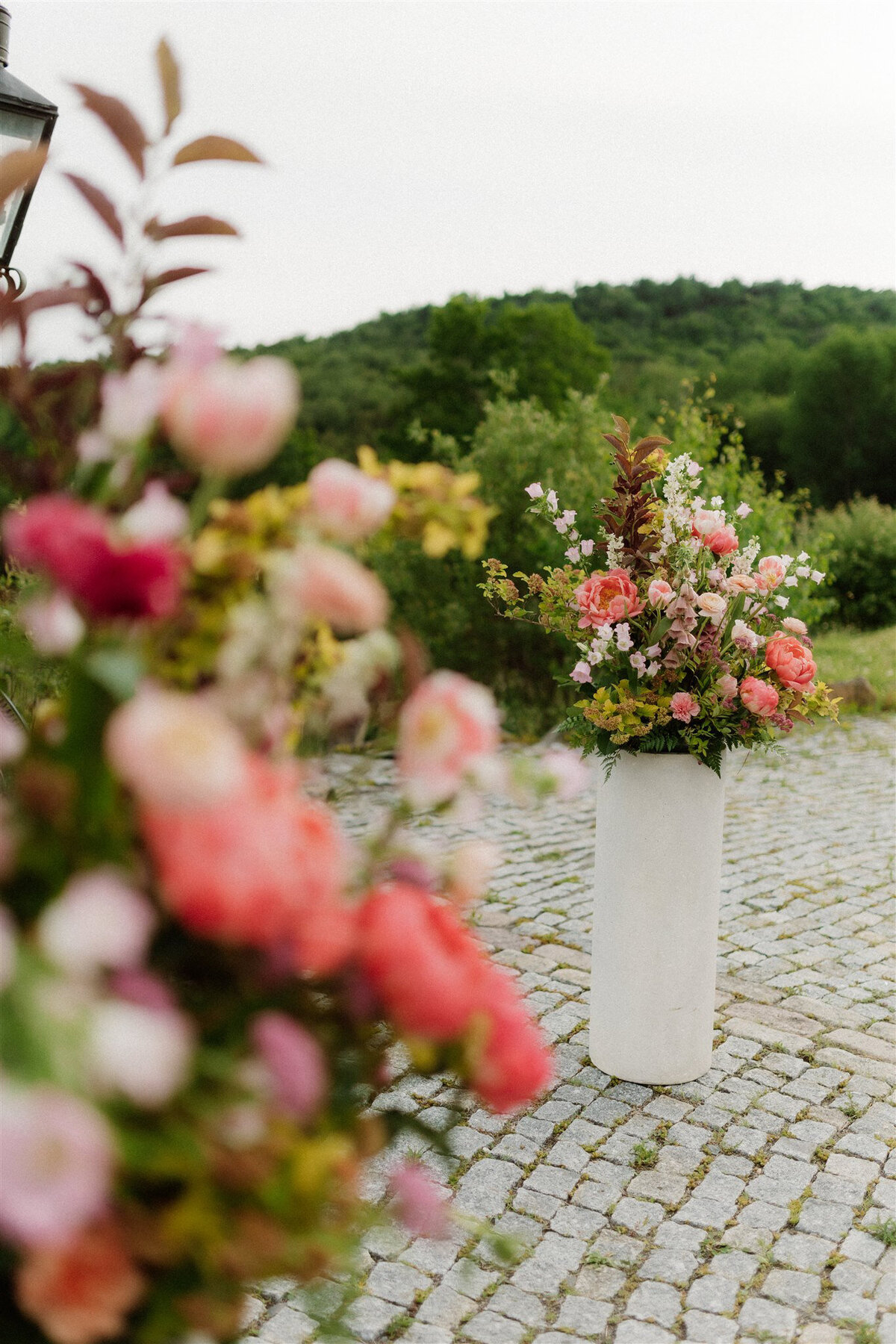 Bright pink, peach, and yellow floral arrangements for a wedding ceremony at Chateau Ste-Agnes.