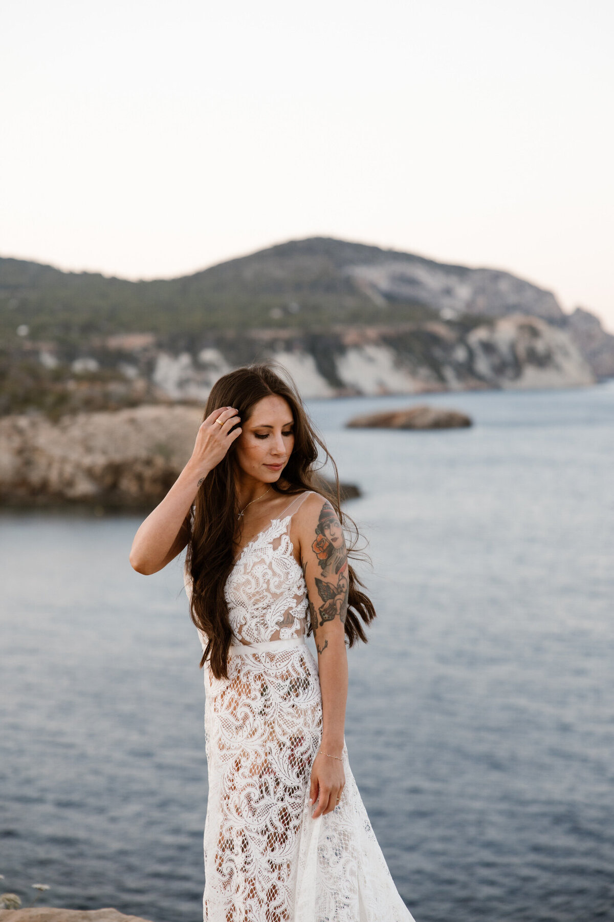 Bride standing in front of the sea on Ibiza during sunrise wedding photoshoot