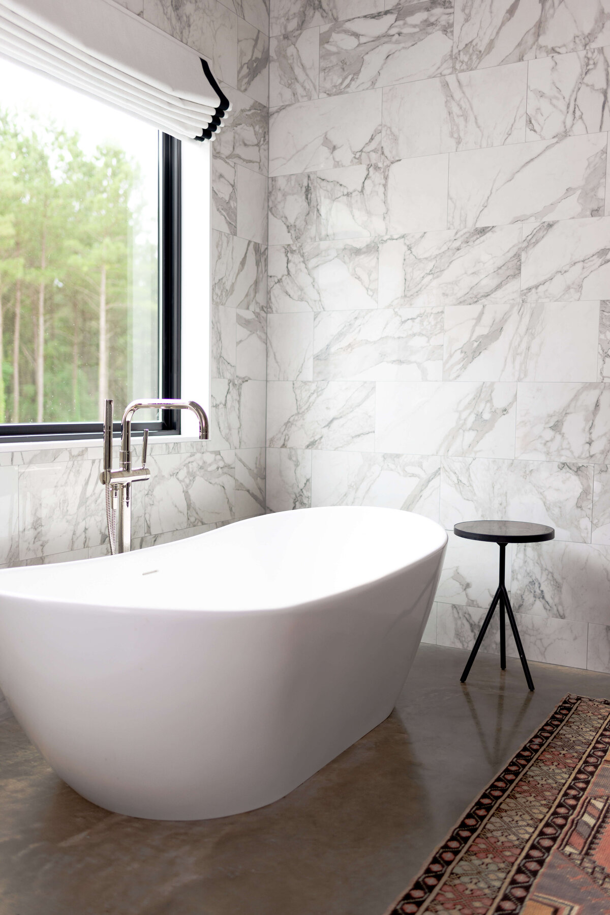 oyster creek studios building belt new build  free standing bathtub in bathroom with marble walls