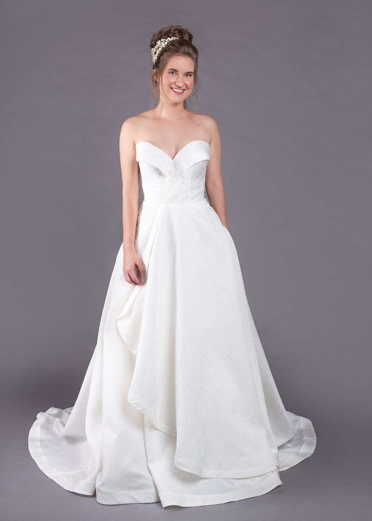 The Eloise bridal style is a strapless, textured wedding dress with pockets by indie bridal designer Edith Elan.