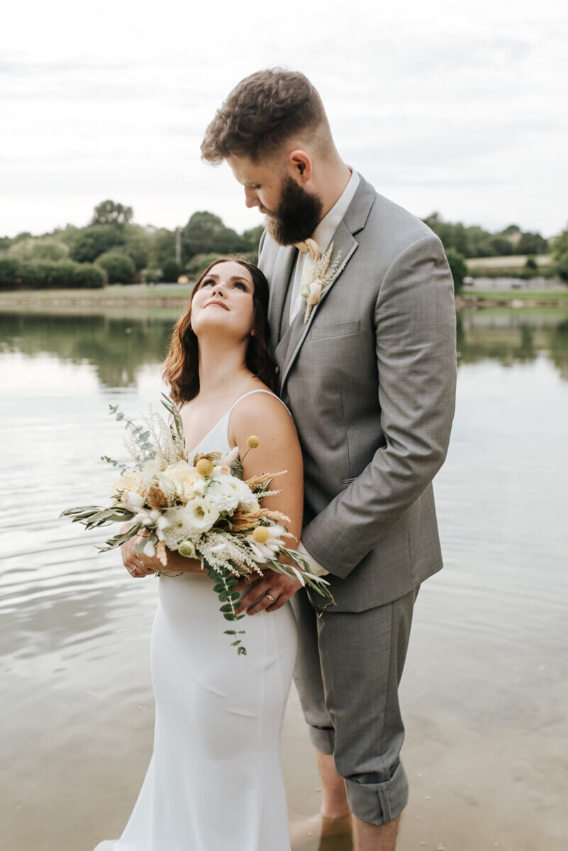bride and groom by the water