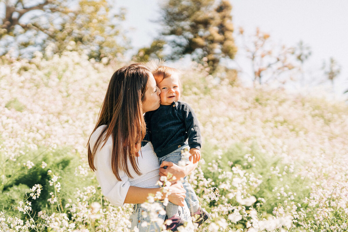 Mother and son at wildflower field during photo session with los angeles family photographer Neide Barbosa