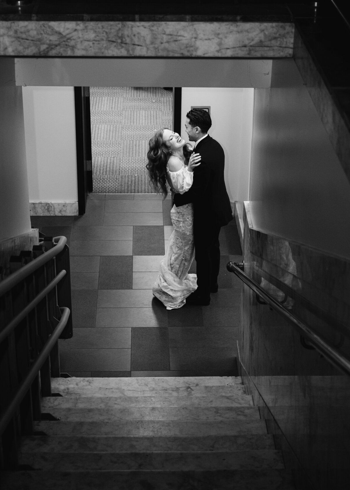 just married couple laughing in black and white
