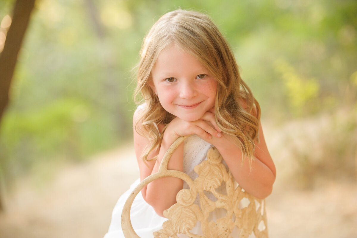 Little girl sitting in a chair along the Boise greenbelt.