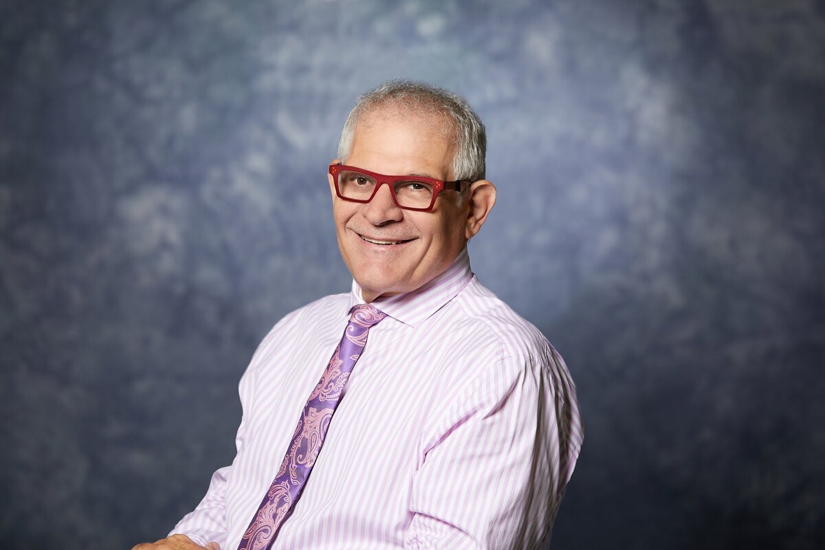 male profile head shot on a blue and grey background for a business called Joe Vella in Cairns.