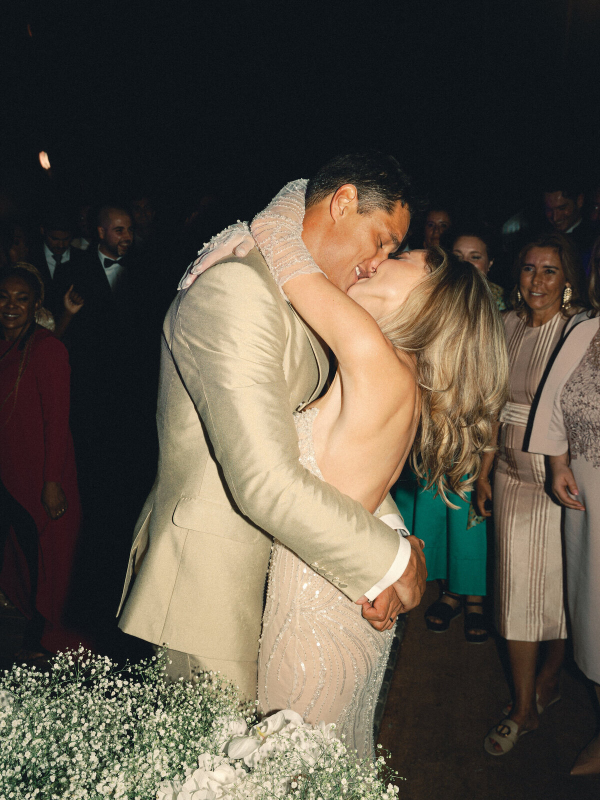 The bride and groom share a kiss after they cut their wedding cake in Quinta da Bellavista for their destination wedding