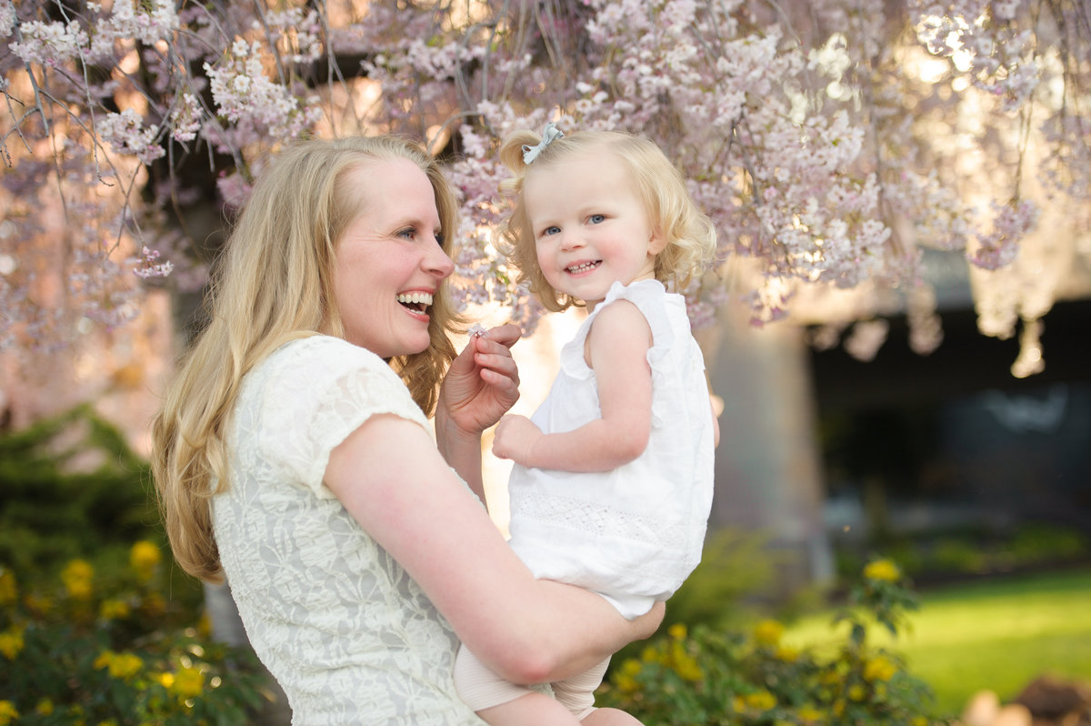 Mom and daugter in front of blooming tree in Downtown Boise.