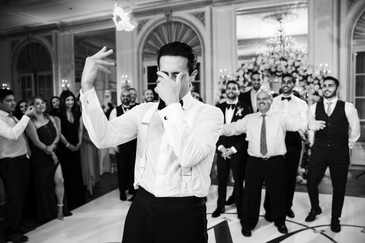 Groom tossing the garter at San Diego wedding