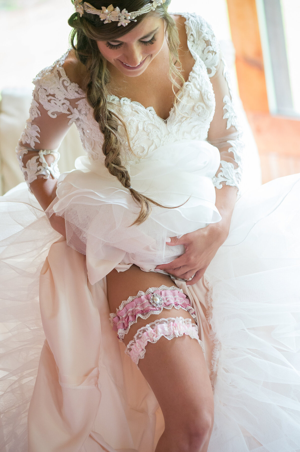 Bride showing garter on her leg.