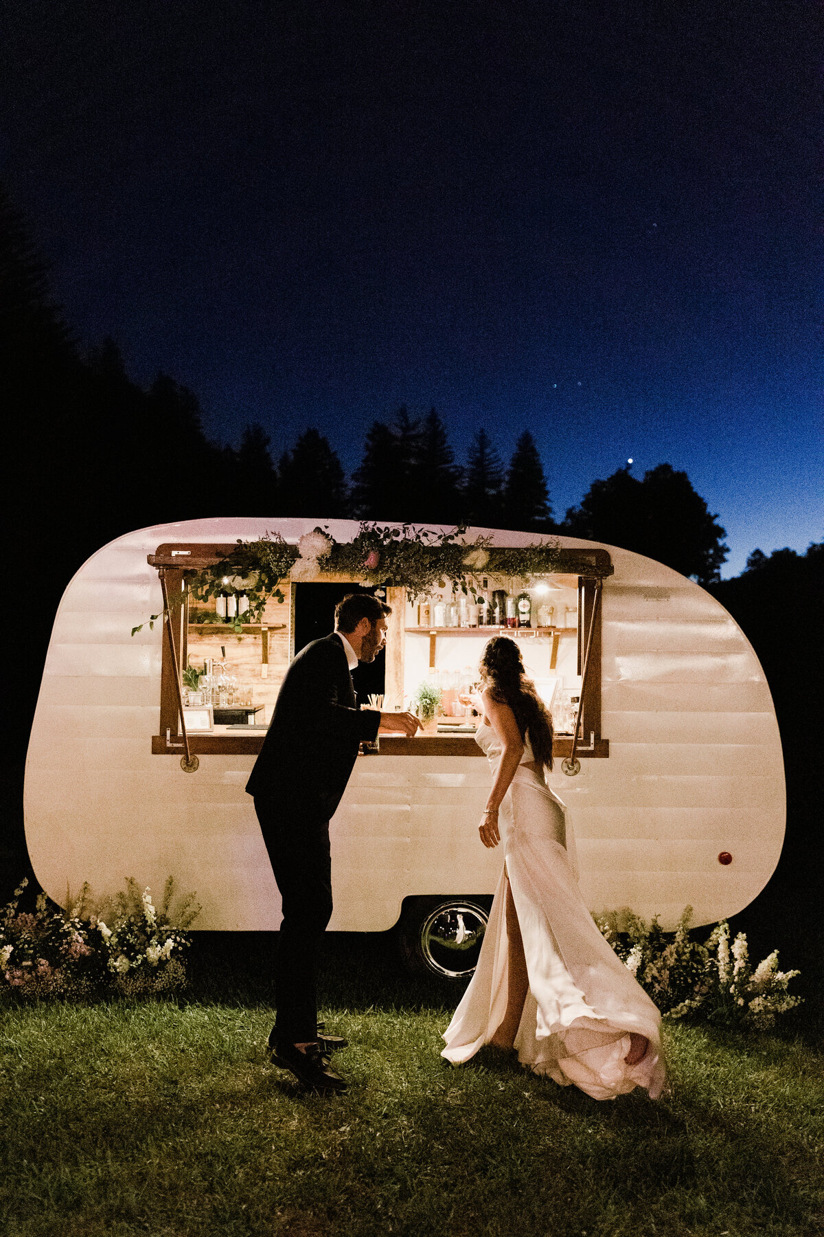 Bride and groom ordering drinks from mobile cocktail bar at Dallenbach Ranch Wedding in Colorado