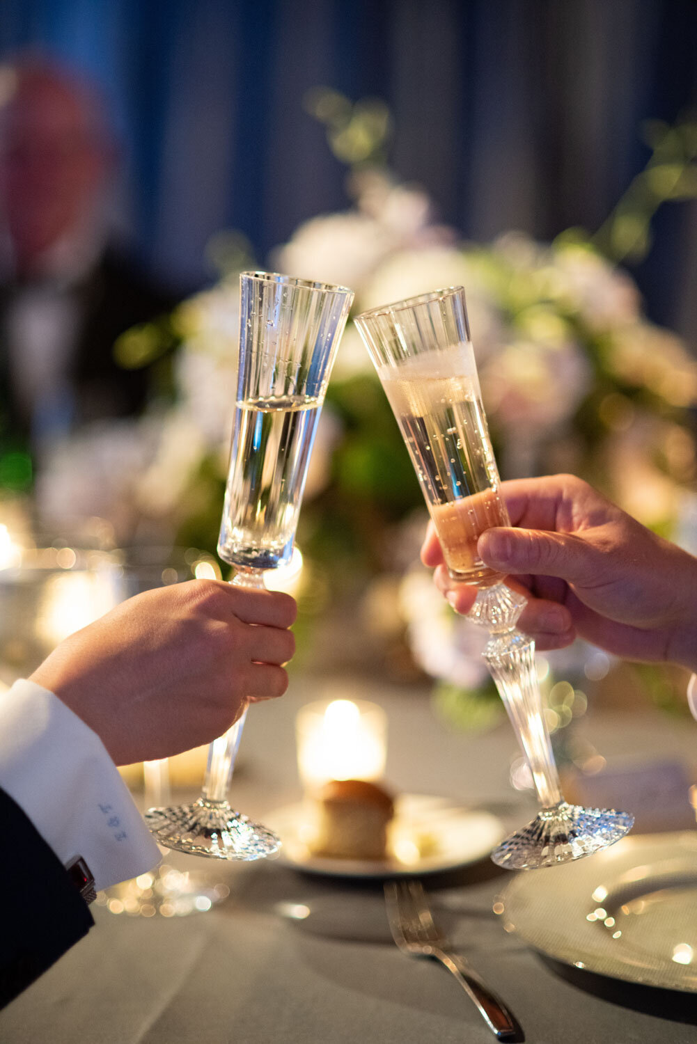 A couple of people toasting with champagne flutes