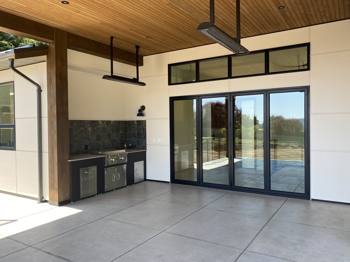 Lake house indoor design with access to patio through steel door.