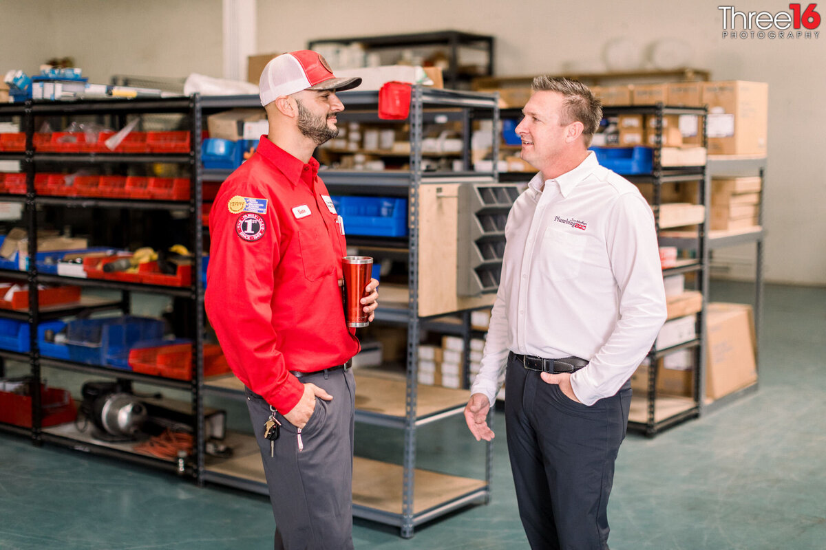 Manager discusses plans with an employee in the shop warehouse