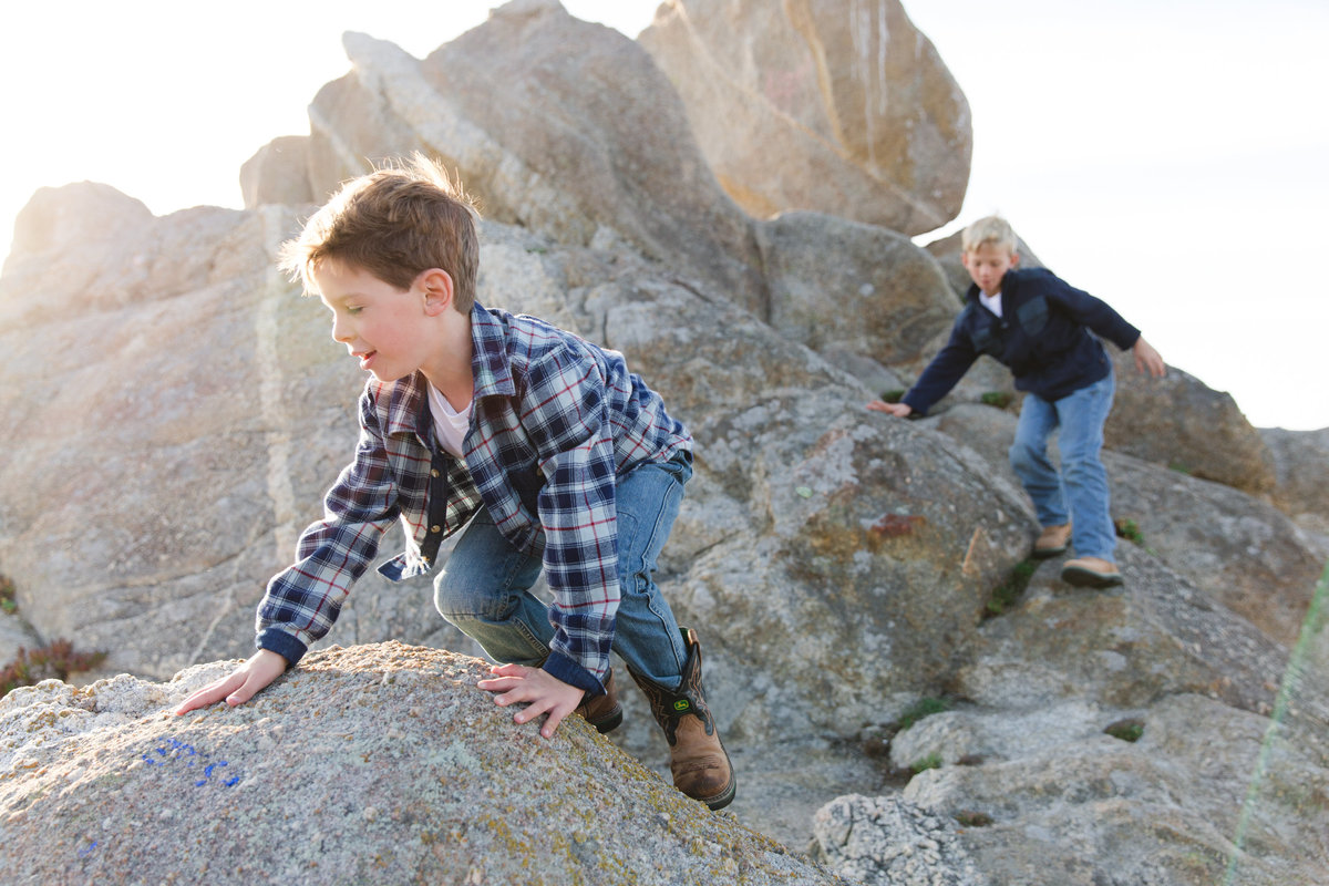 Boys climbing rocks