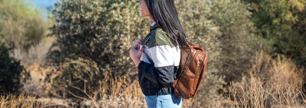 Laci exploring a park and carrying a backpack