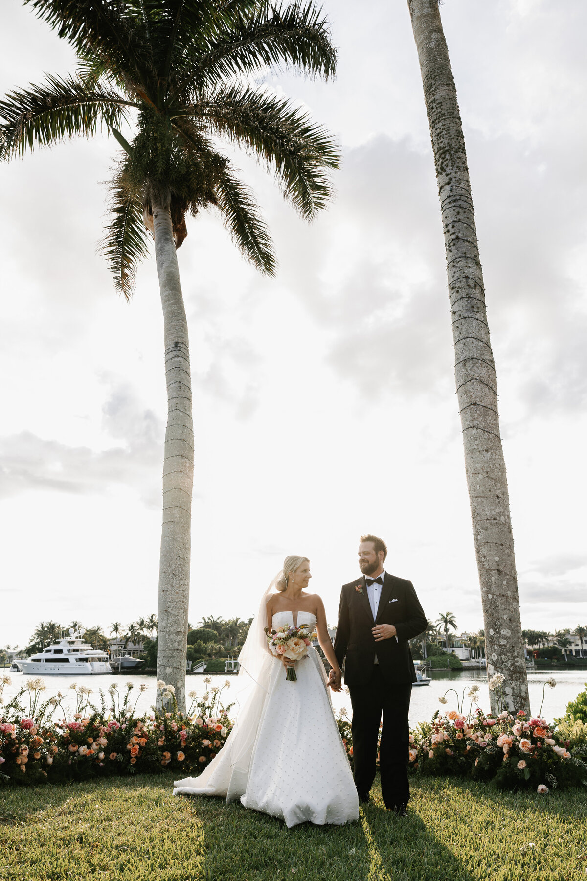 Bride and groom smiling after their wedding ceremony at Port Royal in Naples, Florida. Wedding photography in Naples, FL, captured by Priscila Del Cristo.