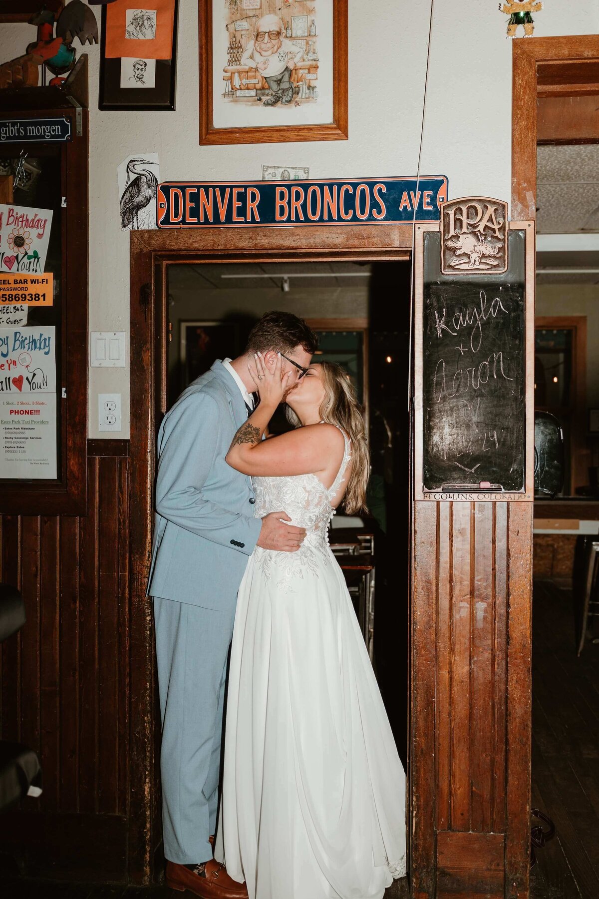 Couple Kissing Under Denver Broncos Sign