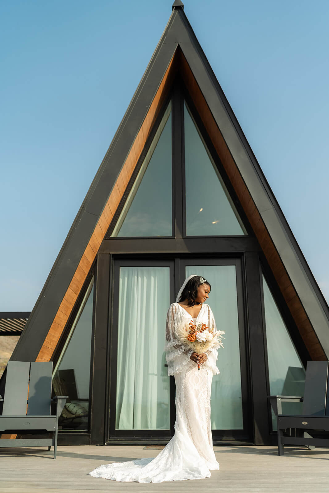 bride standing in front of her A frame getting ready space